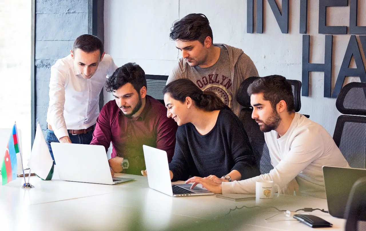 group meeting looking to their laptop